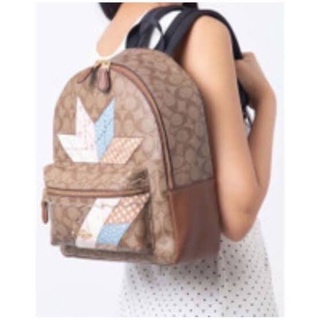 เป้ COACH  (เป้)MEDIUM CHARLIE BACKPACK IN SIGNATURE CANVAS WITH STAR PATCHWORK  KHAKI MULTI