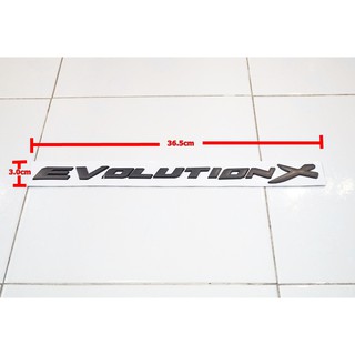 ป้ายโลโก้ตัวนูน พลาสติกสีดำEVOLUTION Xสำหรับติดฝากระโปรงหน้า ขนาด 36.5X3.0 cm ติดตั้งด้วยเทปกาวสองหน้าด้านหลัง