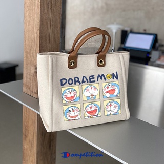 ♕Jingle cat Doraemon Doraemon cat bag สุภาพสตรี 2021 ใหม่อินเทรนด์ high-end แฟชั่นผ้าใบแบบพกพา tote