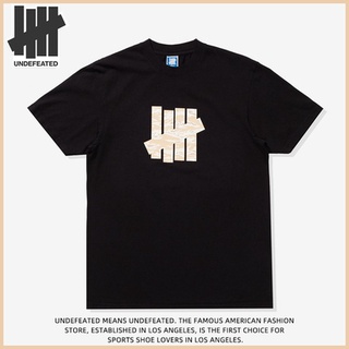 เสื้อยืดแขนสั้นลําลอง ผ้าฝ้าย พิมพ์ลาย undefeated ทรงหลวม สําหรับผู้ชาย และผู้หญิง