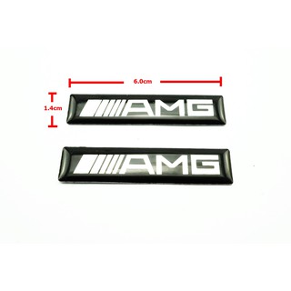 2ชิ้นป้ายโลโก้เลซิ่น AMG พื้นดำขนาด 6.0x1.4cm ติดตั้งด้วยเทปกาวสองหน้าด้านหลัง