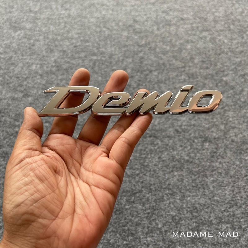 โลโก้ MAZDA Demio สีโครเมี่ยม ขนาด 15.5x2.8cm