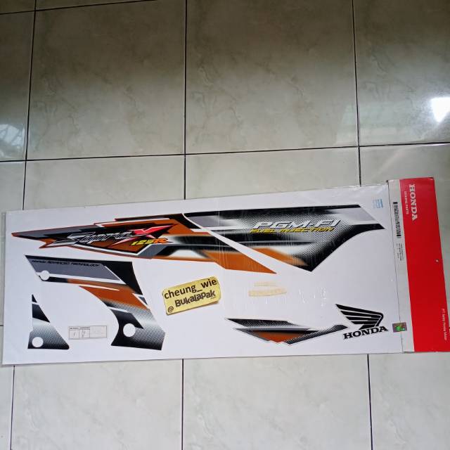 สติ๊กเกอร์ Body Striping Honda supra x 125 R PGM F1 2005 สีส้ม สีดํา original AMM 
871X0KTM770Z7C