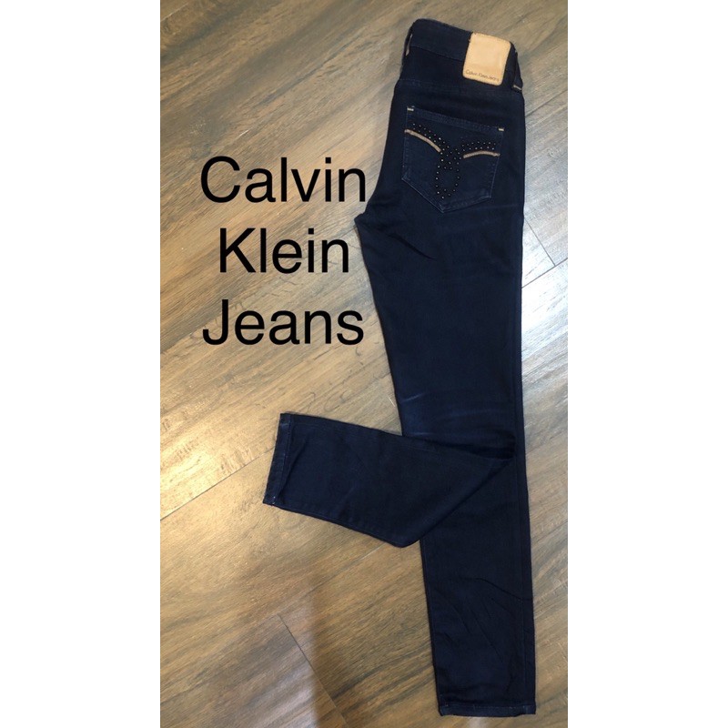 Calvin Klein Jeans กางเกงยีนส์ CK ผ้ายีนส์ยืดได้ แต่งหมุด + เดินเส้นหนังที่กระเป๋าหลัง