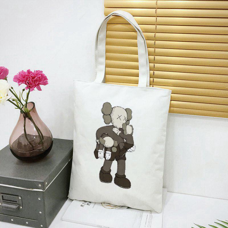 kaws uniqol กระเป๋าผ้าแคนวาส ขนาดใหญ่ ใส่เอกสารได้