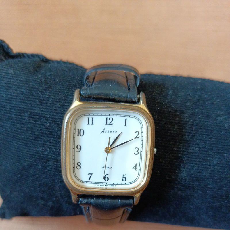 นาฬิกาแบรนด์เนม seiko ระบบถ่านหน้าปัดสีขาว ตัวเรือนสีทองสายหนังสีดำของแท้มือสองสภาพใช้งานได้ปกติ