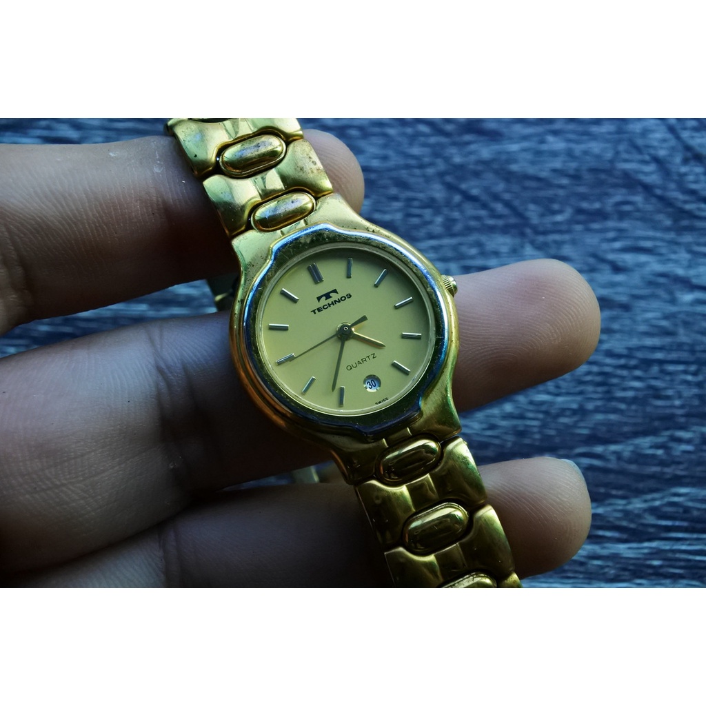 นาฬิกา Vintage มือสองญี่ปุ่น TECHNOS SWISS MADEระบบQuartz ผู้หญิง ทรงกลม กรอบทอง หน้าทอง หน้าปัด 27mm