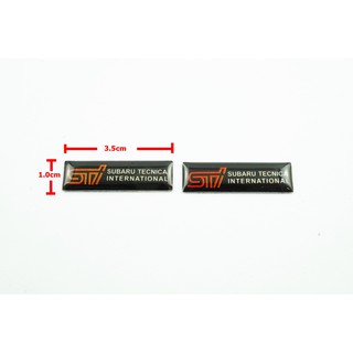 2ชิ้นป้ายโลโก้เลซิ่น STI SUBARU TECNICA INTERNATIONAL พื้นดำขนาดเล็ก 3.5x1.0cm ติดตั้งด้วยเทปกาวสองหน้าด้านหลัง