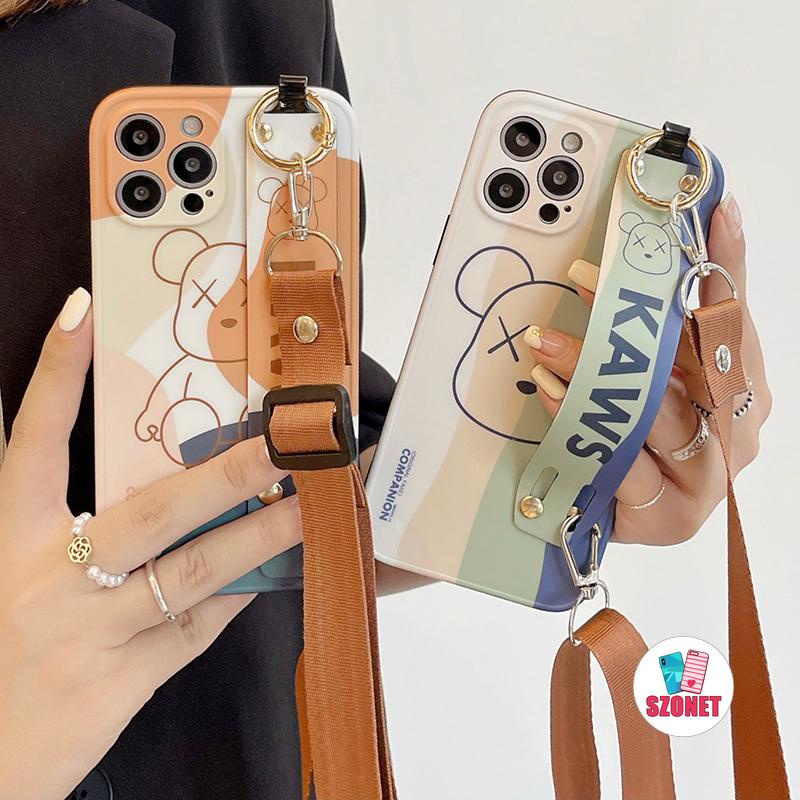 เคสโทรศัพท์มือถือนิ่ม ป้องกันเลนส์ ลาย KAWS พร้อมสายคล้องข้อมือ สําหรับ iPhone 15 14 13 12 11 Pro Max 15 Plus