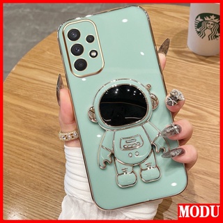 Modu เคสโทรศัพท์มือถือชุบไฟฟ้า ลายนักบินอวกาศ หรูหรา พร้อมขาตั้ง สีมาการอง สําหรับ Samsung Galaxy A13 4G 5G A23 A33 A53 A73 A72 A52 A52S A25 A54 5G