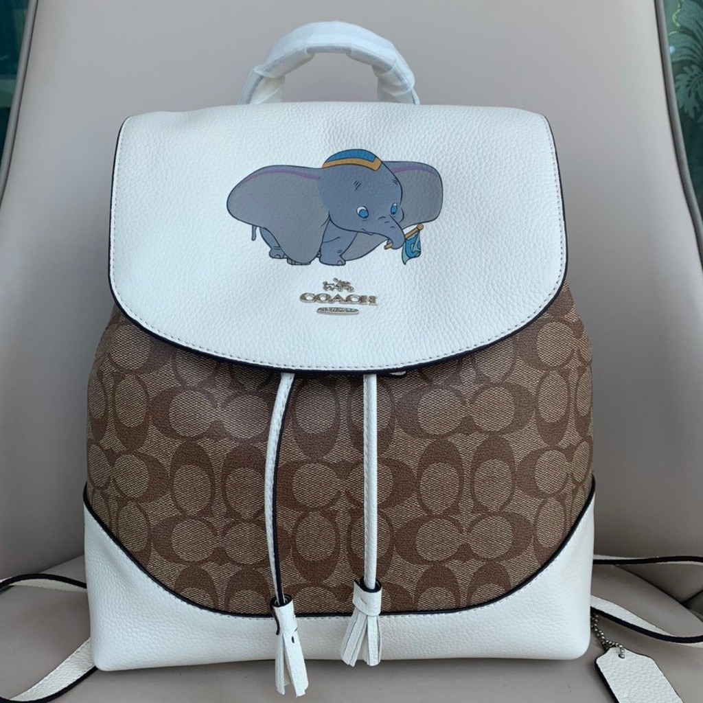 Coach 91121 กระเป๋าเป้สะพายหลัง Disney Elle ในผ้าใบลายเซ็นพร้อมกระเป๋าผู้หญิง Dumbo