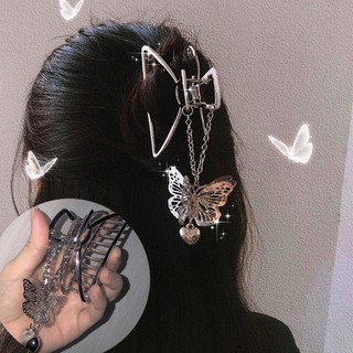 A metal hairpin in the shape of a butterfly, designed for women.