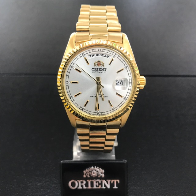 นาฬิกาข้อมือผู้ชาย ORIENT Automatic รุ่น FEV03002WY (ขอบหยัก) สายทอง หน้าขาว
