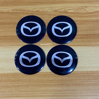 โลโก้* MAZDA โลโก้ฝาครอบล้อ รถ โลโก้ติดดุมล้อ ขนาด : เส้นผ่าศูนย์กลาง 56 mm  (ราคาต่อชุด มี 4 ชิ้น