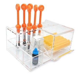 12 holes, 4 slots and 1 applicator dispenser Clear plastic placement for dental materials and applicator holder