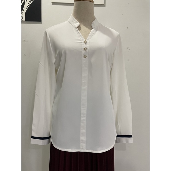 เสื้อเชิ้ตสีขาวแขนยาว คอตั้ง แต่งกระดุมหน้า