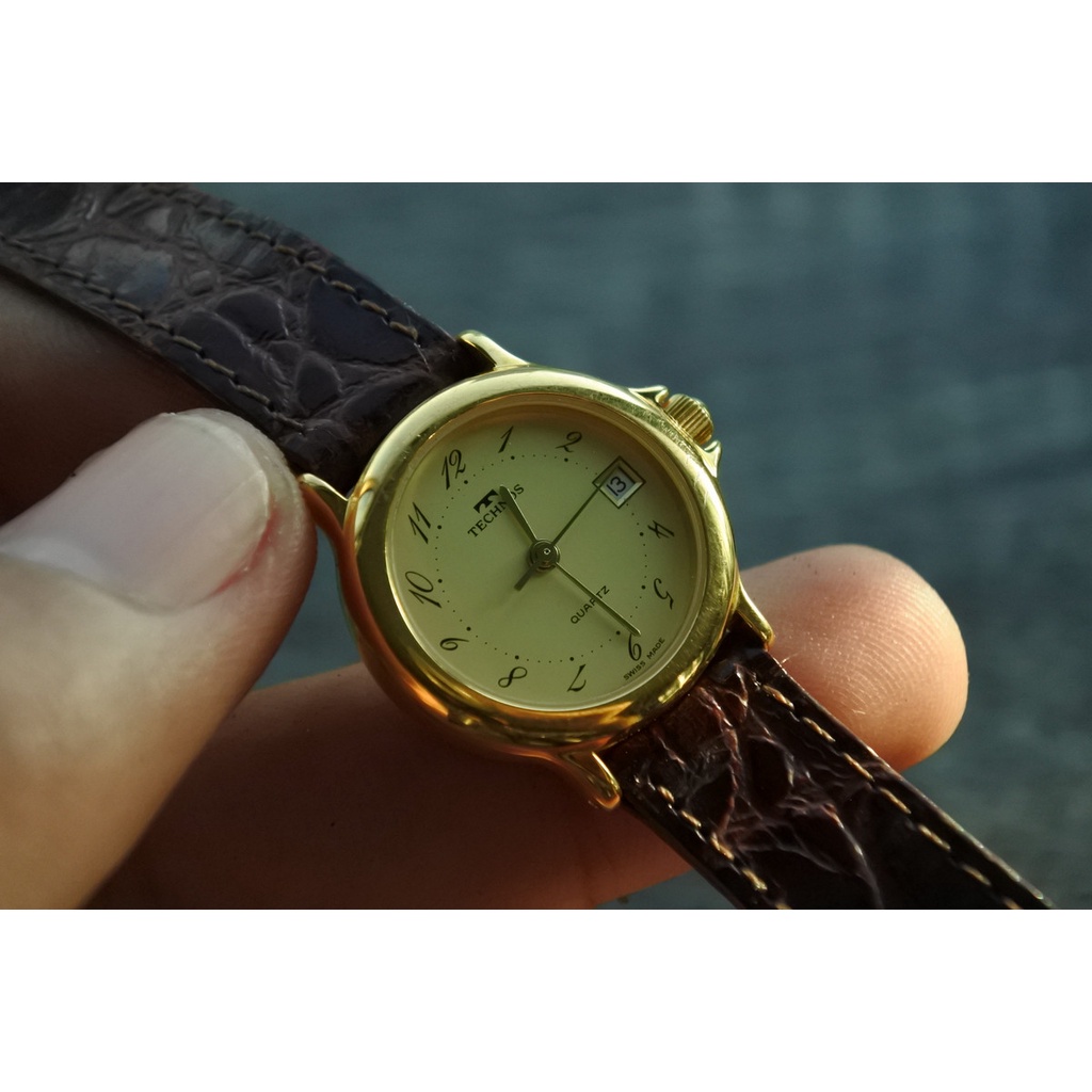 นาฬิกา Vintage มือสองญี่ปุ่น TECHNOS SWISS MADEระบบQuartz ผู้หญิง ทรงกลม กรอบทอง หน้าทอง หน้าปัด 27mm
