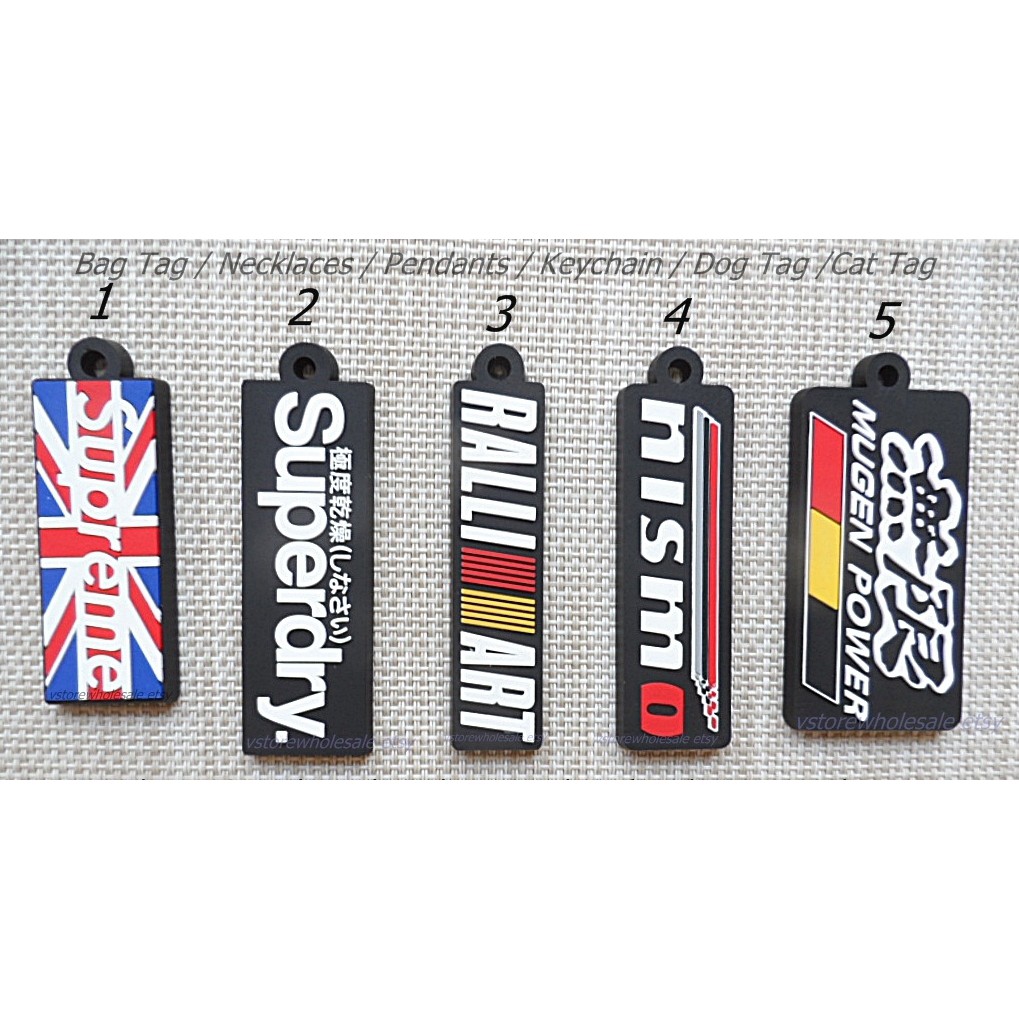 SUPREME , SUPERDRY , NISMO , MUGEN , RALLI ART พวงกุญแจ ป้ายห้อยกระเป๋า สร้อยคอ ที่คั่นหนังสือ Keych
