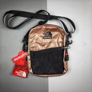 SUPREME X THE NORTH FACE SHOULDER BAG ROSE GOLD AND GOLD METALLIC กระเป๋าสะพายข้างครอสบอดี้ สุพรีม เดอะนอทเฟส สีเมทัลลิค