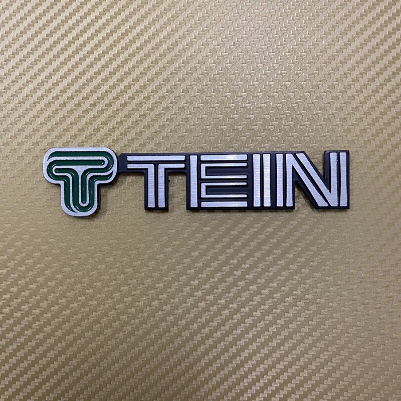 โลโก้* TEIN สีเงืนขอบดำ งานอลูมิเนียม ขนาด* 2.5 x 13.7 cm ราคาต่อชิ้น