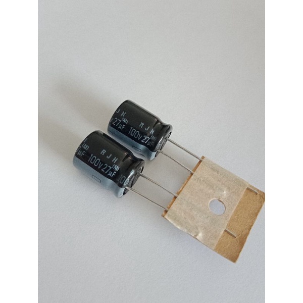 27UF 100V คาปาซิเตอร์ELNAสีดำ105C(แพ็ค10ตัว) C27UF 100V RJH ELNA C 27UF 100V 10x13mm แท้ใหม่แกะกล่อง