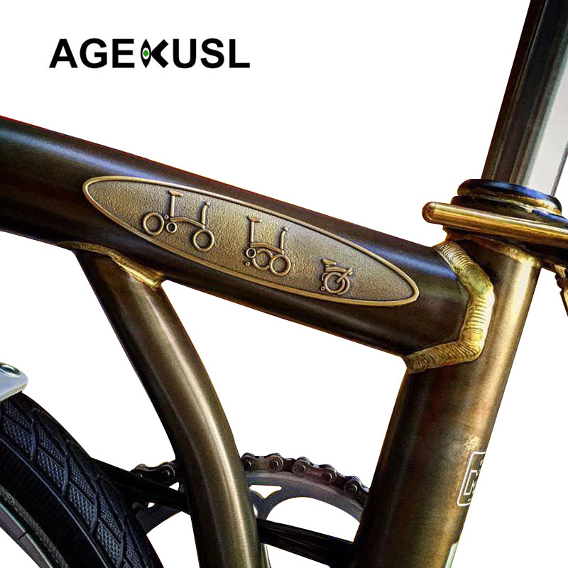 Agekusl สติกเกอร์โลหะ ลายนูน สีบรอนซ์ สําหรับติดตกแต่งกรอบรถจักรยาน Brompton ราคา ถูกที่สุด ดีลบีเคเค