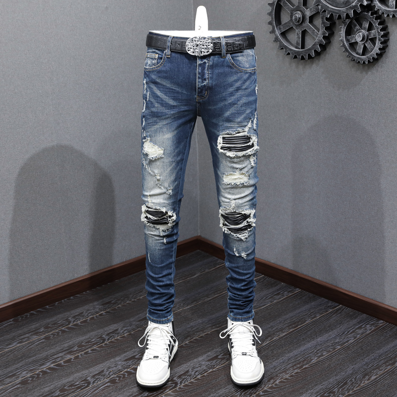 High Street Amiri แฟชั่นผู้ชายกางเกงยีนส์สีฟ้าวินเทจหนังแพทช์ปุ่มออกแบบด้านหน้าคุณภาพดีผู้ชายกางเกงยีนส์ฮิปฮอป