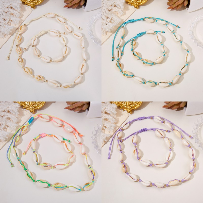 2 ชิ้น / เซต แฟชั่น ที่มีสีสัน เปลือกหอย สร้อยข้อมือ สร้อยคอ แฮนด์เมด เชือกเทียน ปรับได้ สร้อยข้อมือ สร้อยคอ สําหรับผู้หญิง ชายหาด เครื่องประดับ ของขวัญ