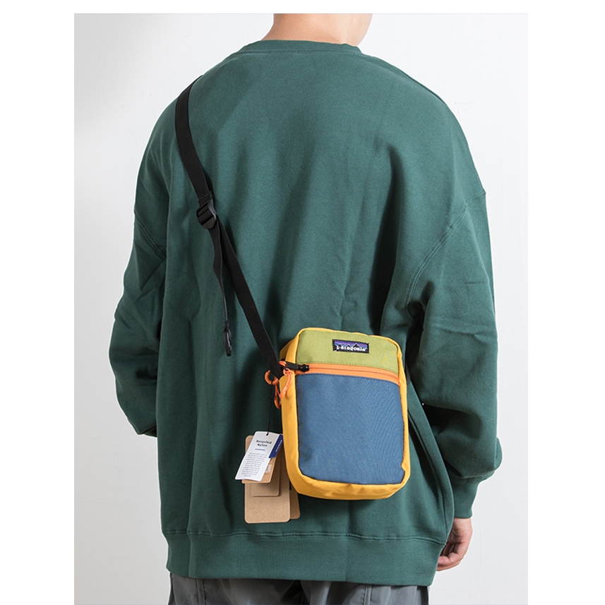 Patagonia กระเป๋าสะพายไหล่ลําลอง ผ้าแคนวาส ทรงสี่เหลี่ยม ขนาดเล็ก ใส่โทรศัพท์มือถือได้ เหมาะกับการพกพาเล่นกีฬา