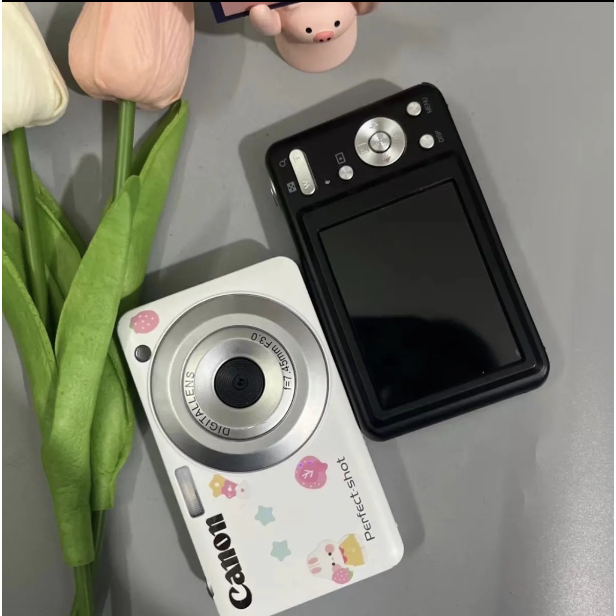 จัดส่งด่วน กล้องดิจิตอลแคมปัส CCD Canon พร้อมกล้องนักเรียนความละเอียดสูง 56 ล้านพิกเซลเดียวกัน 4K ระดับเริ่มต้นย้อนยุคการ์ดขนาดเล็กเดินทางใหม่
