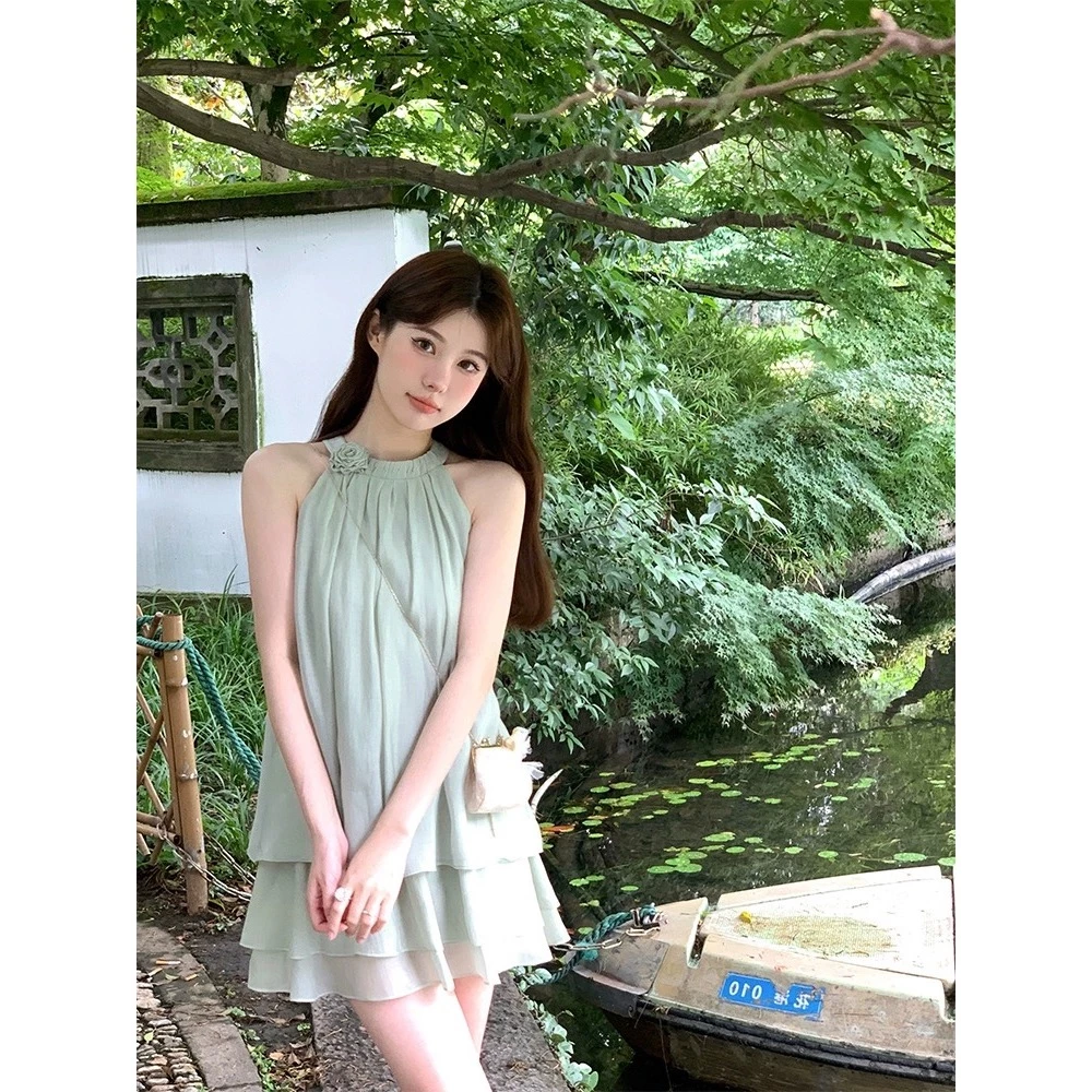 ชุดเสื้อผ้าแขนกุดสีเขียวเข้มที่มีคอกลมและกระโปรงกางเกงที่เข้ารูปสูงเพื่อปกปิดเข่าและแสดงรูปร่างที่ผอมเพรียวของผู้หญิงในฤดูร้อน
