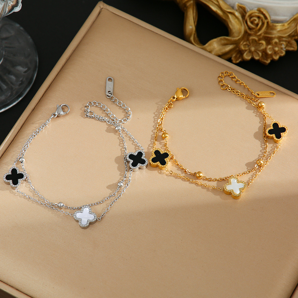 ญี่ปุ่นสไตล์เกาหลีสองชั้นสีดําสีขาวเชลล์สองด้านโคลเวอร์สี่ใบไทเทเนียม