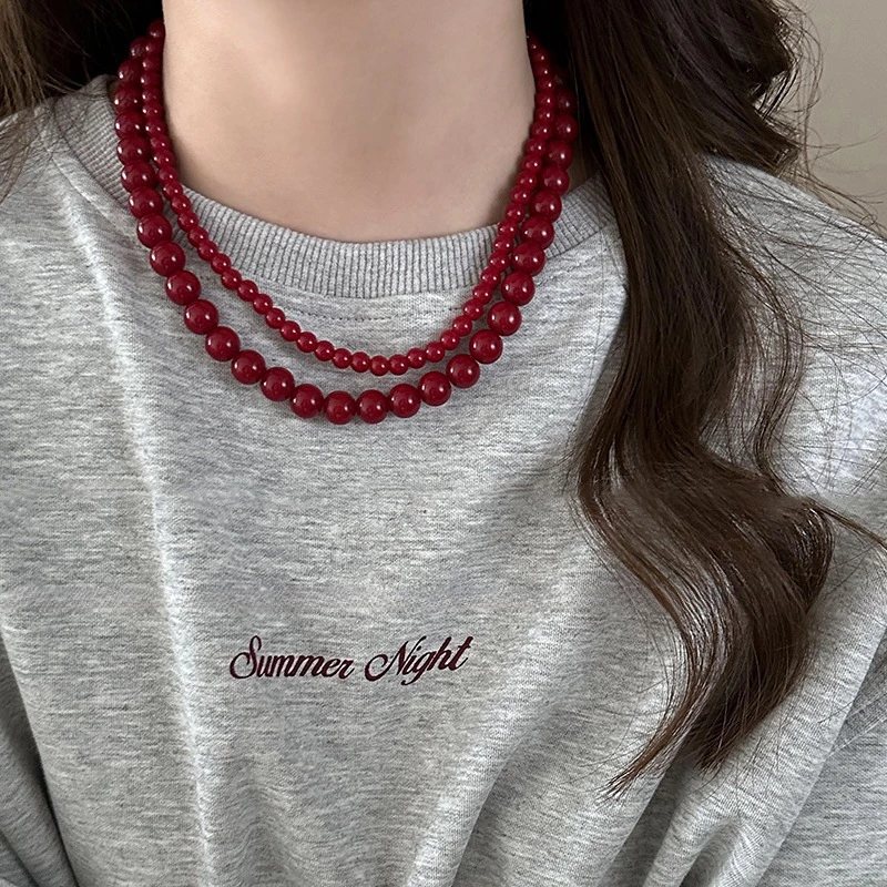 Ancora สร้อยคอจี้ลูกปัดสีแดงผู้หญิงการออกแบบเฉพาะความรู้สึกโซ่เสื้อกันหนาวย้อนยุคความรู้สึกอาวุโสฤดูใบไม้ร่วงและฤดูหนาวอุปกรณ์เสริม