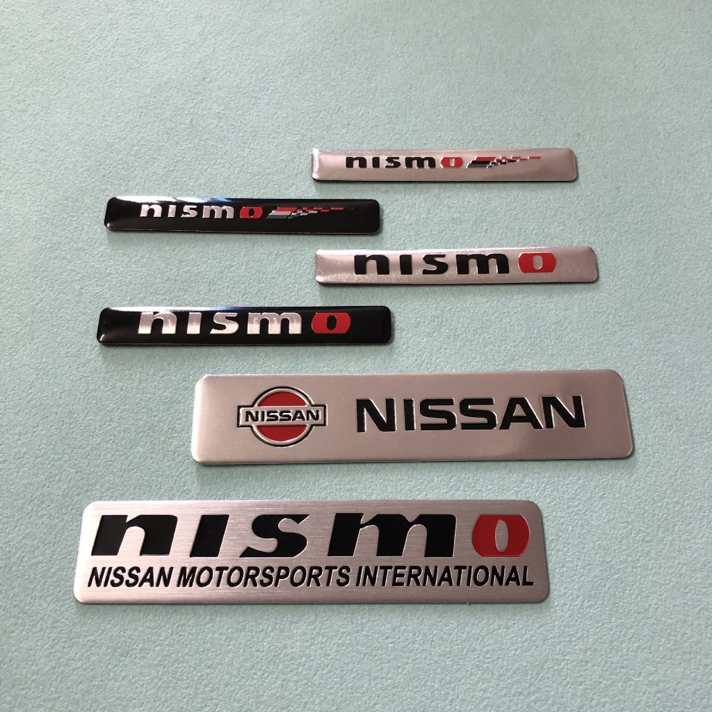 เหมาะสําหรับ Nissan Qijun Sylvanian Teana Versa EasyCard Altima nismo สติกเกอร์รถดัดแปลงสติกเกอร์โลหะพวงมาลัยป้ายอลูมิเนียม Armada Navara Juke Leaf Fender ป้ายด้านข้างหางสติกเกอร์ตกแต่ง