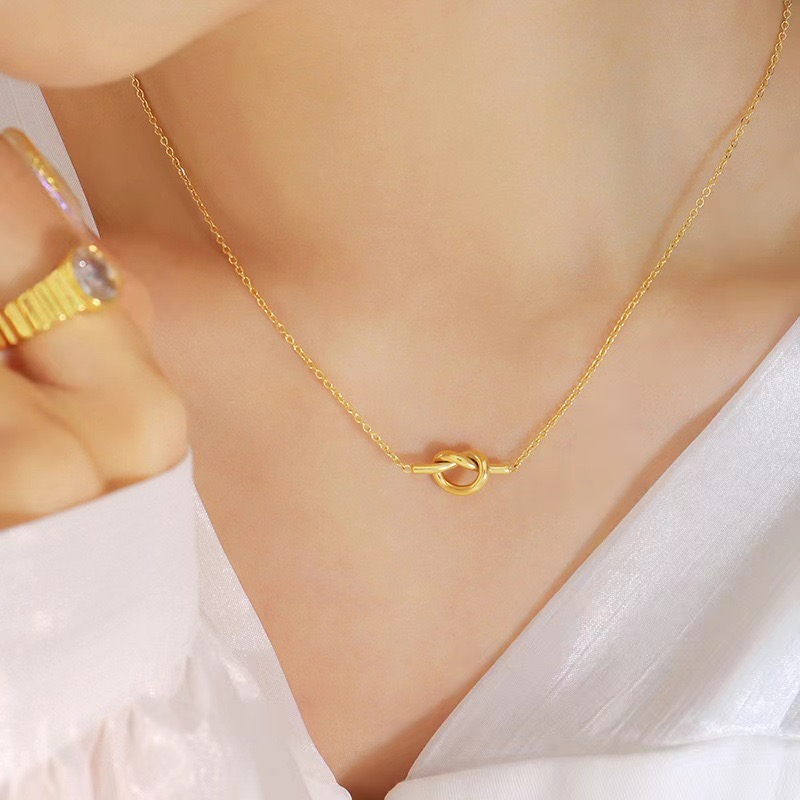 ญี่ปุ่นสไตล์เกาหลีที่เรียบง่ายกลวงผูกปมไทเทเนียมเหล็กสร้อยคอต่างหูสีการเก็บรักษาชุดเครื่องประดับ