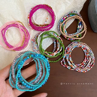 หลากสี หลายสีข้าวลูกปัดซ้อนสวมสร้อยข้อมือแสงหรูหราความรู้สึกระดับสูงของอารมณ์สตริงชนกลุ่มน้อยแฟชั่นลมแห่งชาติเครื่องประดับมือ