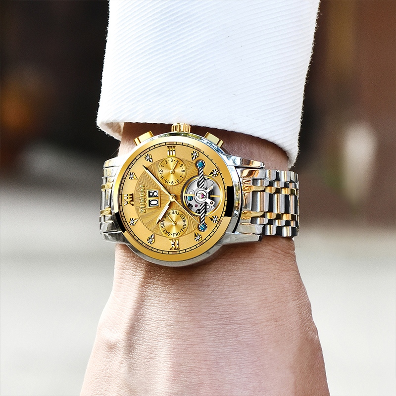 ZUNPAI นาฬิกาข้อมือผู้ชายสายสแตนเลสแบบ Tourbillon อัตโนมัติ พร้อมหน้าต่างกลวง หน้าปัดทรงกลม ทนทานต่อรอยขีดข่วน นาฬิกาแฟชั่นสำหรับธุรกิจ เรียบง่ายและลำลอง กันน้ำ เรืองแสง ปฏิทินถาวร ฟังก์ชันปฏิทินรายสัปดาห์