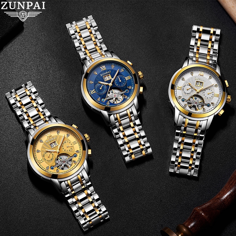 ZUNPAI นาฬิกาข้อมือผู้ชายสายสแตนเลสแบบ Tourbillon อัตโนมัติ พร้อมหน้าต่างกลวง หน้าปัดทรงกลม ทนทานต่อรอยขีดข่วน นาฬิกาแฟชั่นสำหรับธุรกิจ เรียบง่ายและลำลอง กันน้ำ เรืองแสง ปฏิทินถาวร ฟังก์ชันปฏิทินรายสัปดาห์