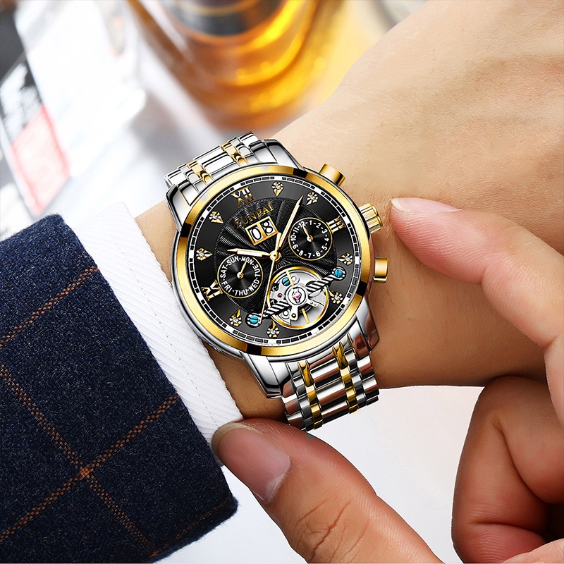 ZUNPAI นาฬิกาข้อมือผู้ชายสายสแตนเลสแบบ Tourbillon อัตโนมัติ พร้อมหน้าต่างกลวง หน้าปัดทรงกลม ทนทานต่อรอยขีดข่วน นาฬิกาแฟชั่นสำหรับธุรกิจ เรียบง่ายและลำลอง กันน้ำ เรืองแสง ปฏิทินถาวร ฟังก์ชันปฏิทินรายสัปดาห์