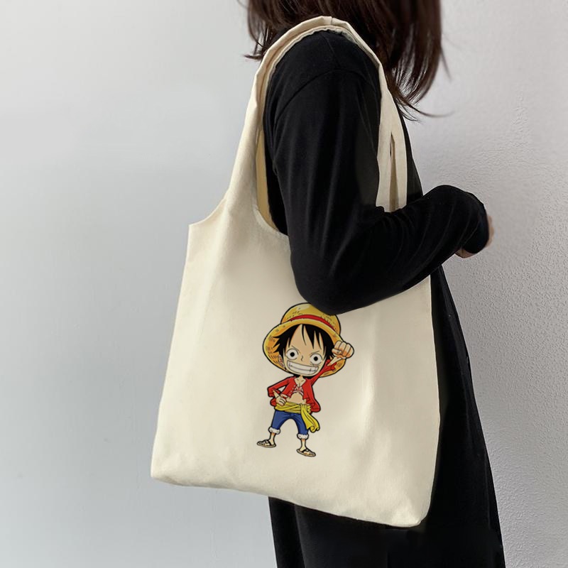กระเป๋าโท้ต One Piece Luffy Zoro อะนิเมะนักเรียนผ้าใบความจุขนาดใหญ่สาวสไตล์เกาหลีผู้หญิงกระเป๋าสะพายไหล่สุภาพสตรีกระเป๋าถือสลิง