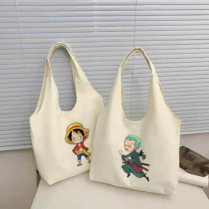 กระเป๋าโท้ต One Piece Luffy Zoro อะนิเมะนักเรียนผ้าใบความจุขนาดใหญ่สาวสไตล์เกาหลีผู้หญิงกระเป๋าสะพายไหล่สุภาพสตรีกระเป๋าถือสลิง