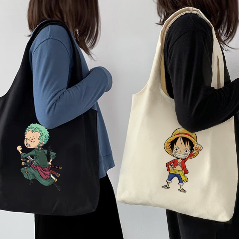 กระเป๋าโท้ต One Piece Luffy Zoro อะนิเมะนักเรียนผ้าใบความจุขนาดใหญ่สาวสไตล์เกาหลีผู้หญิงกระเป๋าสะพายไหล่สุภาพสตรีกระเป๋าถือสลิง