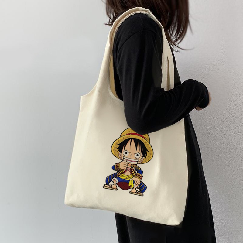 กระเป๋าโท้ต One Piece Luffy Zoro อะนิเมะนักเรียนผ้าใบความจุขนาดใหญ่สาวสไตล์เกาหลีผู้หญิงกระเป๋าสะพายไหล่สุภาพสตรีกระเป๋าถือสลิง