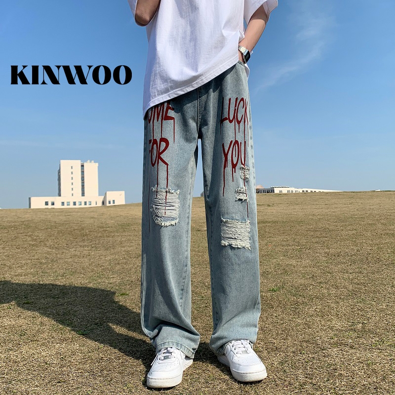 Kinwoo กางเกงยีนขายาวลําลอง ทรงหลวม พิมพ์ลายตัวอักษรถ้ํา สไตล์ฮิปฮอป สตรีท สําหรับผู้ชาย