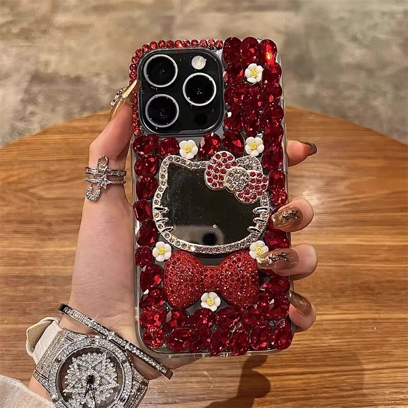 Bling สีแดง Hello Kitty กระจกแต่งหน้าเคสโทรศัพท์สําหรับ iPhone 17 11 12 13 14 15 16 Pro Max 7 8 Plus X XR XS Max Luxury Glitter Rhinestone ดอกไม้เพชรโบว์อะคริลิคกันกระแทก
