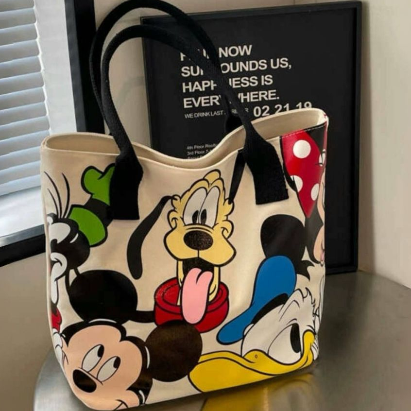 [กรุงเทพฯ จัดส่ง] กระเป๋าสะพายผ้าแคนวาสเกาหลียอดนิยมกระเป๋าถือมีซิปกระเป๋าผ้าการ์ตูนความจุขนาดใหญ่พิมพ์การ์ตูนเหมาะสําหรับผู้หญิงแ