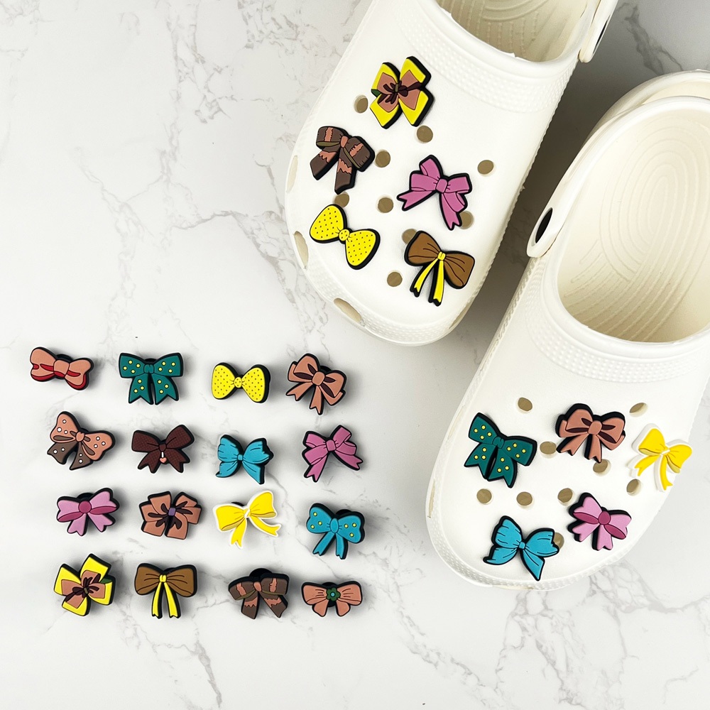 น่ารัก jibz รองเท้า Charms croc DIY โบว์ Bowknot ตกแต่ง Clogs น่ารักสําหรับสาวผู้หญิงปุ่มหัวเข็มขัดคุณภาพสูงรองเท้ารองเท้าแตะอุปกรณ์ตกแต่ง