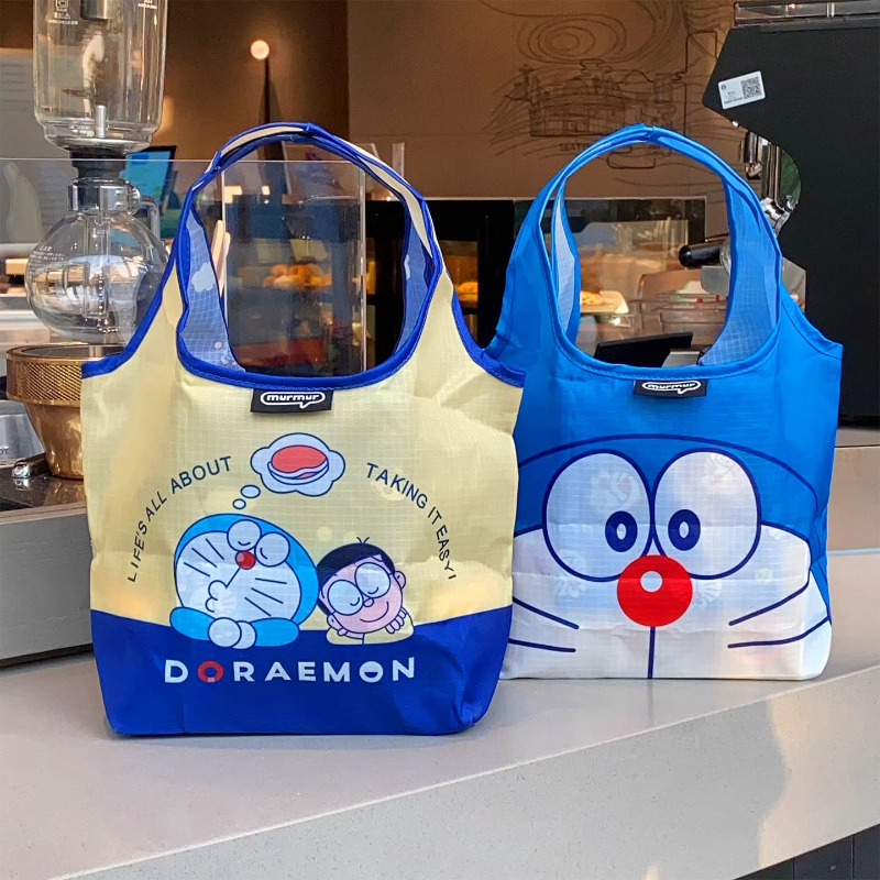 โดราเอมอนกระเป๋าเบนโตะมัลติฟังก์ชั่ถ้วยน้ําแบบพกพาที่เก็บเครื่องดื่มถุงอาหารกลางวันแบบพกพาน่ารักสไตล์ใหม่