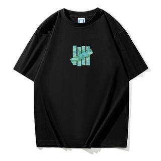 Undefeated เสื้อยืดคอกลม แขนสั้น พิมพ์ลายพราง สีเขียวทหาร ทรงหลวม สําหรับผู้ชาย และผู้หญิง