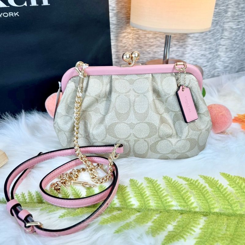 Nora Kisslock Crossbody In Signature Canvasขนาด 8 1/2" (L) x 5 1/2" (H) x 3" (W)